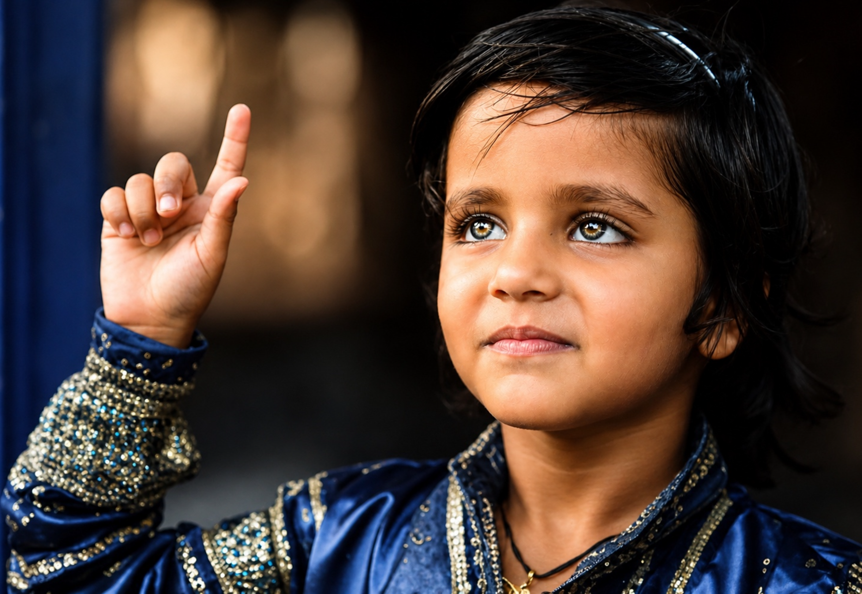 Child pointing up toward heaven